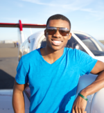 A student pilot leans on his aircraft.